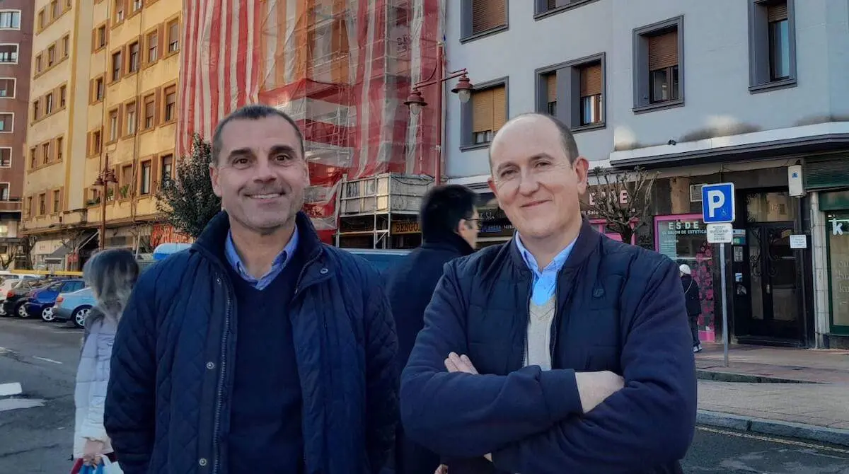 Juan Antonio Pizarro y Carlos Fernández con la obra de una fachada detrás