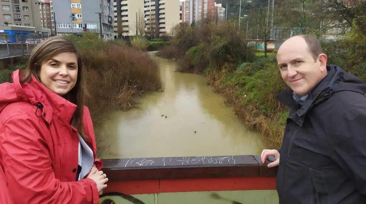 Carlos Fernández y Alba Delgado en una pasarela sobre el río Castaños a la altura de Retuerto